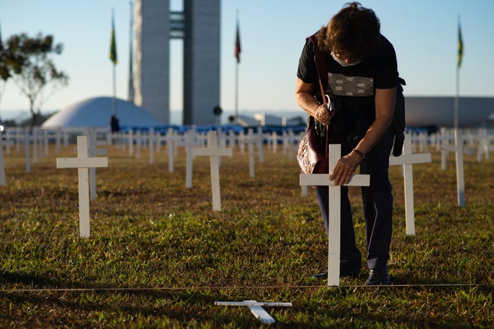 A protester nails a cross during a demonstration in honor of victims of coronavirus (COVID-19) in front Nacional Congress in Brazil.