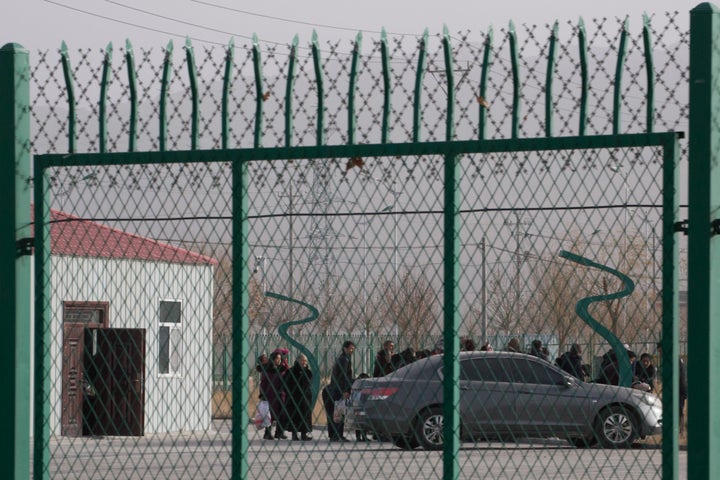 In this Dec. 3, 2018, photo, residents line up inside the Artux City Vocational Skills Education Training Service Center at the Kunshan Industrial Park in Artux in western China's Xinjiang region. 