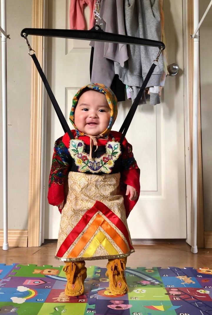 Six-month-old Brave Yazzie of Onion Lake, Sask. gets ready for a dance session.