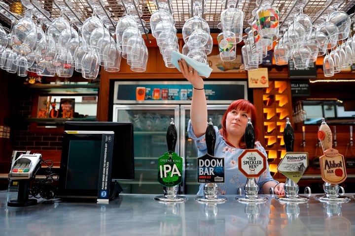 A member of staff at a Wetherspoon's pub in north London cleans glasses in preparation for pubs to reopen on Saturday.