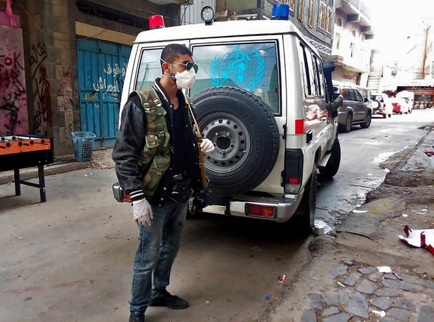 This May 2020 photo provided by a Yemeni community activist shows a man waiting for an ambulance to collect...