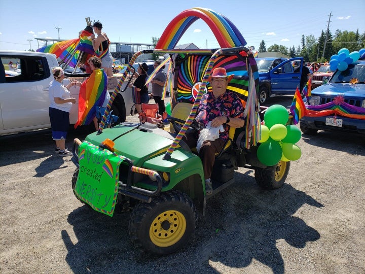 A participant in the Pride parade on June 27, 2020 poses with his decorated vehicle in Emo, Ont.