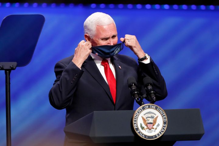 Vice President Mike Pence removes his mask to make comments at First Baptist Church Dallas.