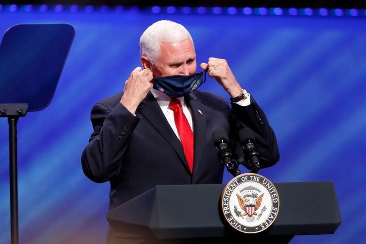 Vice President Mike Pence removes his mask to make comments at First Baptist Church Dallas.