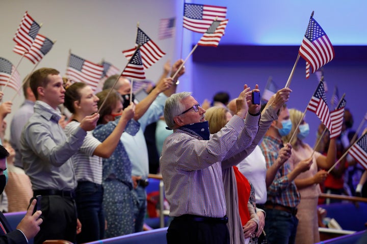 Attendees wave flags at First Baptist Church Dallas on June 28, 2020.