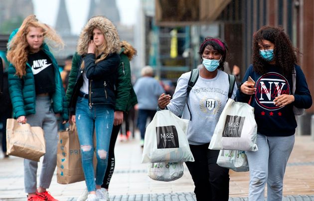 Shoppers in Scotland. Some are wearing masks, others aren't.