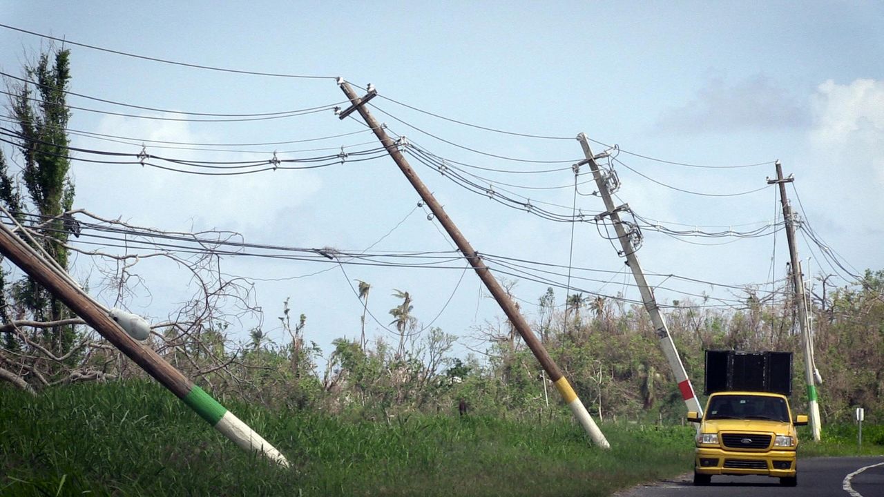 Power lines hang precariously on the side of the road on Highway 118, near San Isidro, Puerto Rico.
