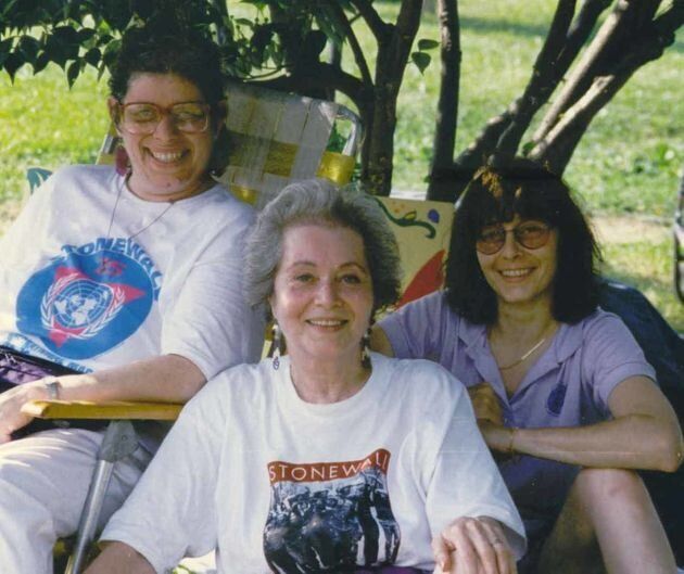 Frances Goldin and her daughters, with Goldin wearing a shirt referencing the Stonewall riots in 1969 that paved the way for modern-day Pride celebrations.
