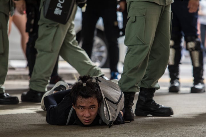 Riot police detain a man as they clear protesters taking part in a rally against a new national security law in Hong Kong on