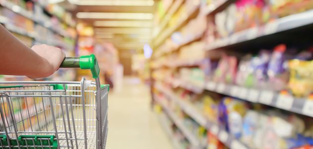 A shopping trolley in a supermarket aisle.