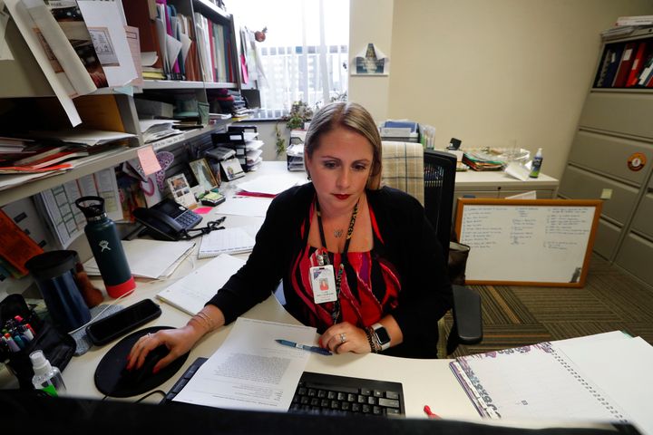 Jennifer Gottschalk, environmental health supervisor of the Toledo-Lucas County Health Department, works in her office in Toledo, Ohio. “Being yelled at by residents for almost two hours straight last week on regulations I cannot control left me feeling completely burned out,” she said in mid-June.