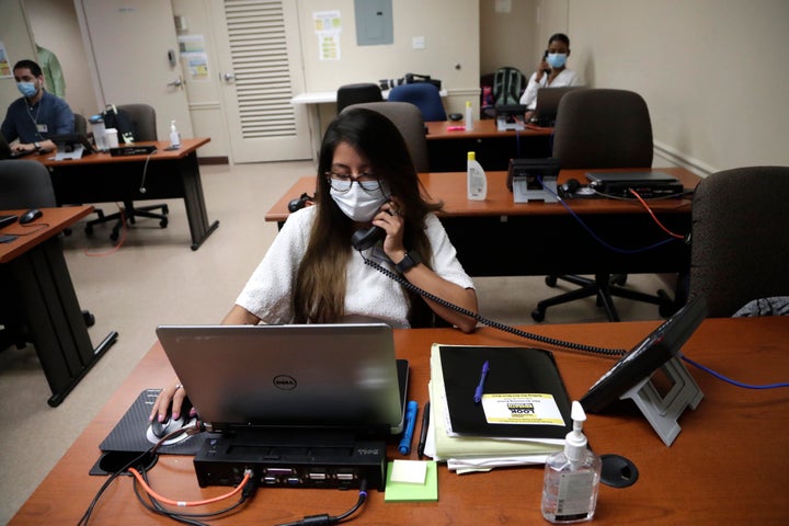 Maria Fernanda works on COVID contact tracing at the Florida Department of Health in Miami-Dade County in Doral, Florida, in May. In state after state, local health departments charged with doing the detective work of running down the contacts of coronavirus patients are falling well short of the number of people needed to do the job.