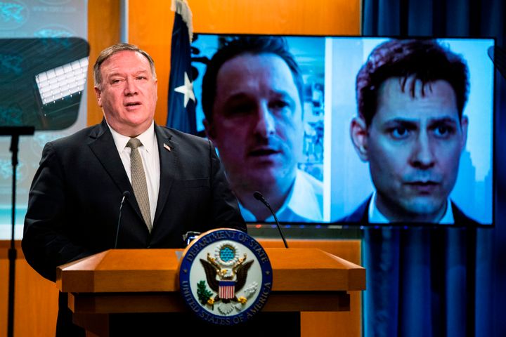 Michael Spavor, a Canadian businessman and Michael Kovrig, right, a former Canadian diplomat, detained in China since December 2018, are shown on a video monitor as U.S. Secretary of State Mike Pompeo, speaks during a news conference at the State Department on July 1, 2020, in Washington.