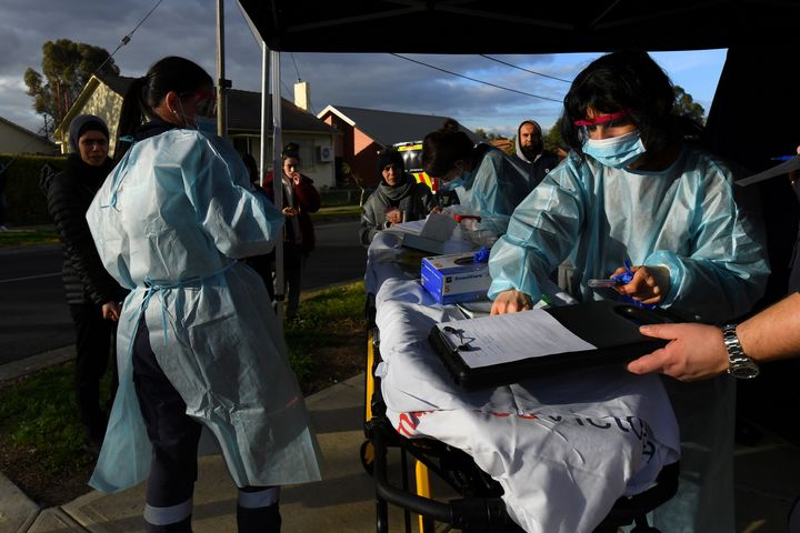 Medical professionals work with members of the public at a pop-up coronavirus disease. AAP Image/James Ross via REUTERS