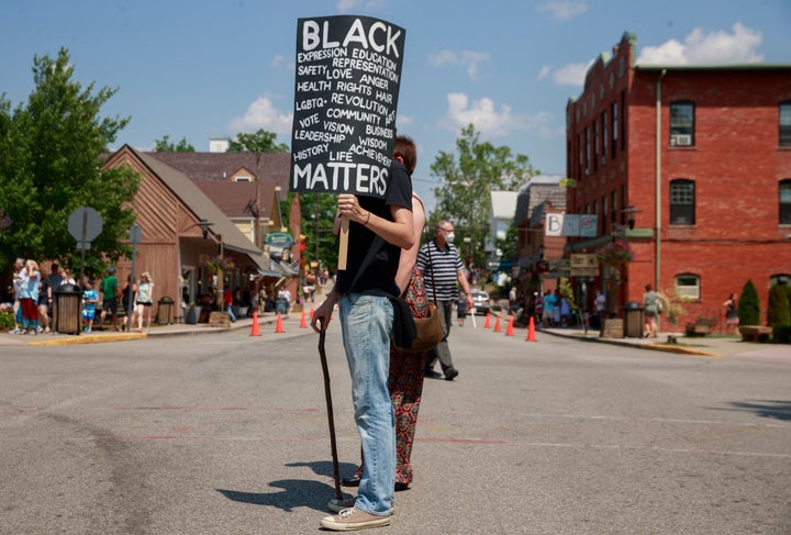 A man holds a placard during a demonstration in solidarity with Black Lives Matter in Nashville, Indiana, on June 20. Nashville is about 80 miles south of Carmel.