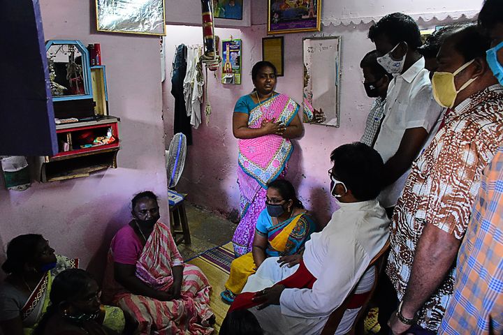 A church priest (C bottom) consoles family members of Jayaraj, 58, and son Bennix Immanuel, 31, allegedly tortured at the hands of police in Sathankulam, Thoothukudi district in Tamil Nadu on June 28, 2020. 