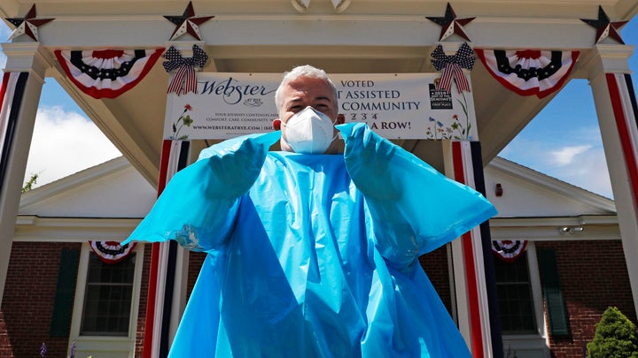 Brendan Williams, president of the New Hampshire Health Care Association, wears an isolation gown with no sleeve openings for hands. The gown was provided by the federal government for use at a senior care center.