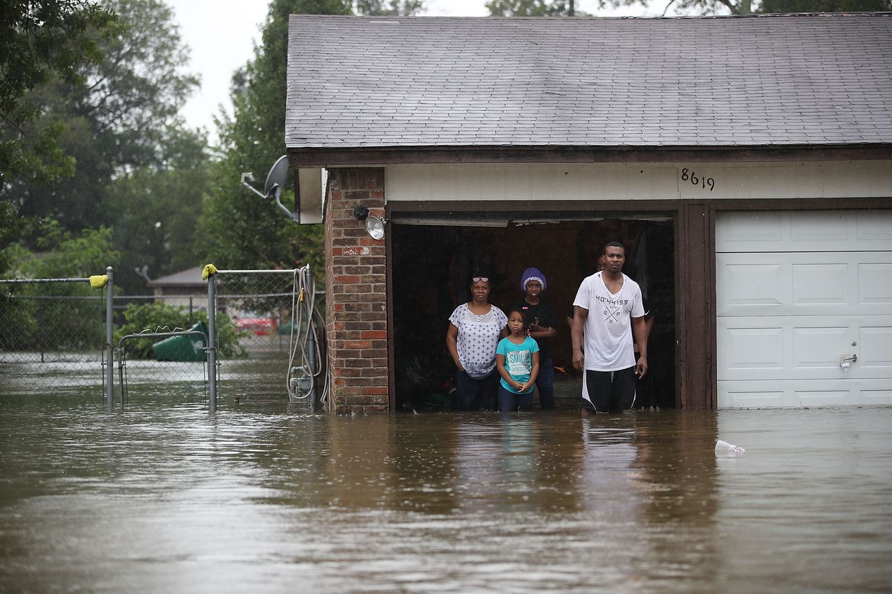People in Houston wait to be rescued from their flooded homes after the area was inundated by Hurricane Harvey on Aug. 28, 2017.