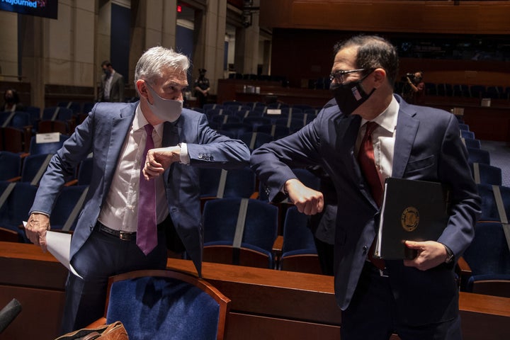 Federal Reserve Chairman Jerome Powell (left) and Treasury Secretary Steven Mnuchin bump elbows at the conclusion of a June 3