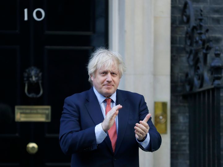 Boris Johnson applauds on the doorstep of 10 Downing Street during the weekly Clap for Carers.