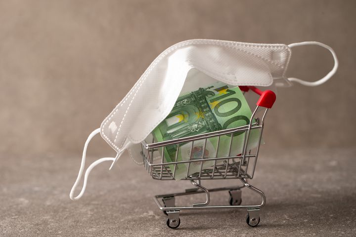 Euro banknote with shopping cart and face mask