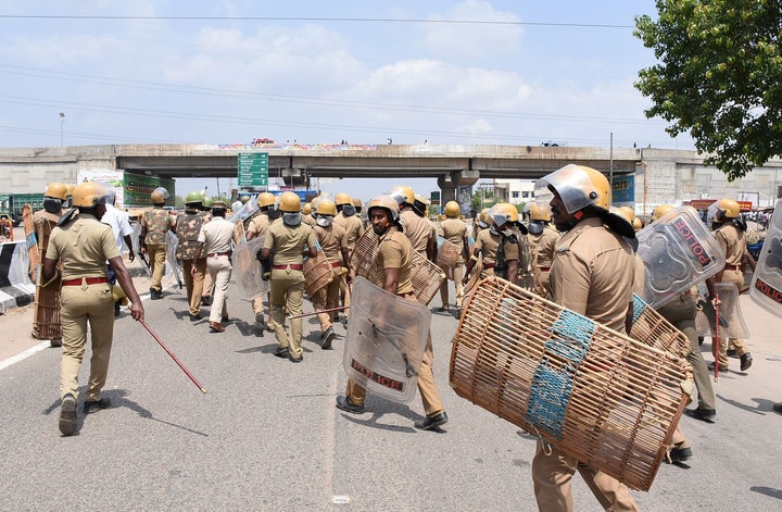 Indian police officials move towards protestors in Thoothukudi on May 22, 2018. Around 13 people were killed when police fired at a crowd protesting against the proposed expansion of a copper smelter plant run by Sterlite Corporation.