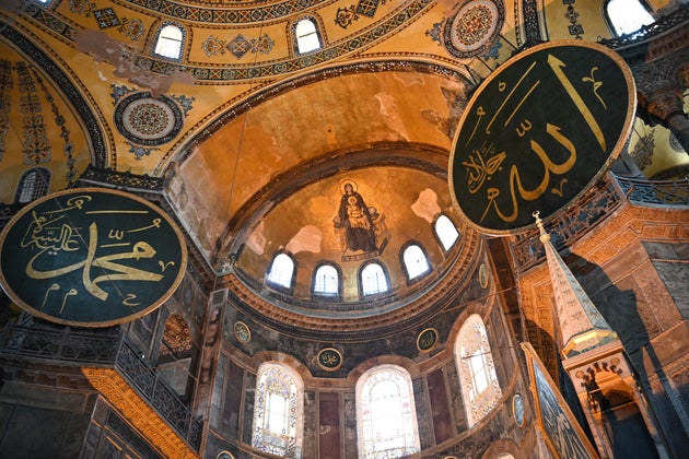 This picture taken on July 2, 2020 shows the Virgin Mary and child fresco and a calligraphic Roundels with Arabic letters bearing the name of Allah and other Muslim prophets hanging on the dome of the Hagia Sophia museum, in Istanbul, Turkey. - Turkey's top court considered Thursday whether Istanbul's emblematic landmark and former cathedral Hagia Sophia can be redesignated as a mosque, a ruling which could inflame tensions with the West. (Photo by Ozan KOSE / AFP) (Photo by OZAN KOSE/AFP via Getty Images)