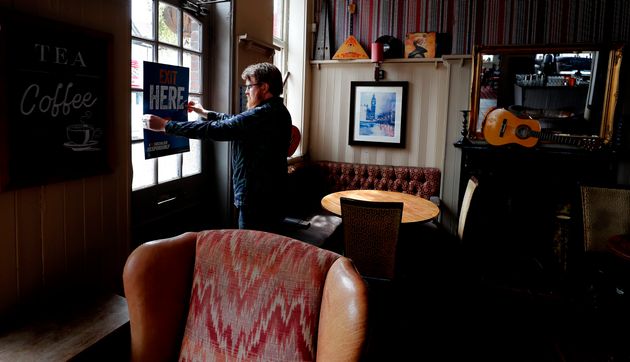 Signs being put in place instructing on social distancing at the Chandos Arms pub in London