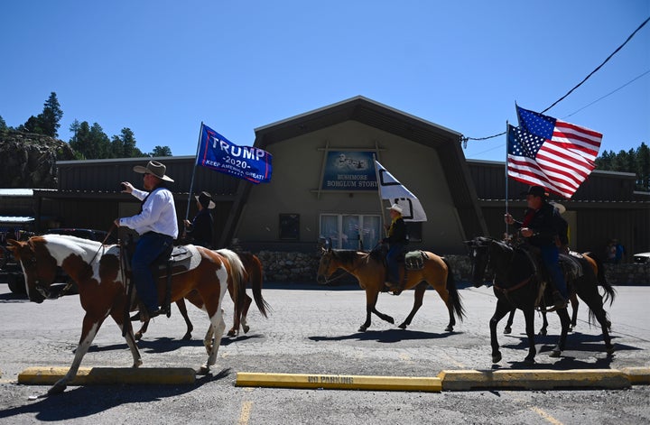 Supporters of US President Donald Trump ride through Keystone, South Dakota, on July 3, 2020, before a fireworks celebration for the Fourth of July holiday at Mount Rushmore National Monument and the visit of US President Donald Trump. (Photo by Andrew Caballero-Reynolds / AFP) (Photo by ANDREW CABALLERO-REYNOLDS/AFP via Getty Images)