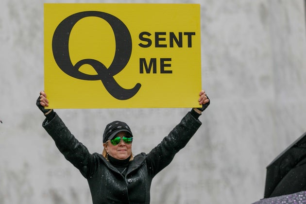 A QAnon conspiracy theorist demonstrates at an anti-quarantine protest in Salem, Oregon, on May