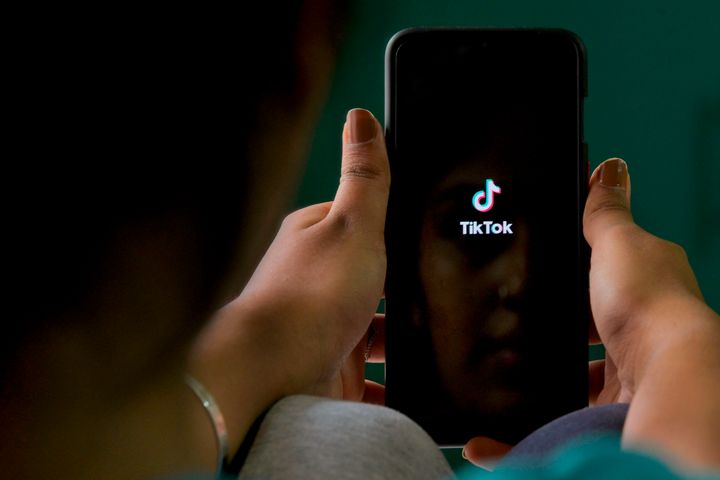 A mobile user browses through the Chinese owned video-sharing 'Tik Tok' app on a smartphone in Bangalore on June 30, 2020.