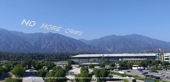 A mock up of the skytyped phrase "NO MORE CAMPS," chosen by artist Tsuru for Solidarity -- Karen Ishizuka. It will be seen over the Santa Anita Assembly Center during the In Plain Sight day of action over July 4 weekend in Los Angeles. 