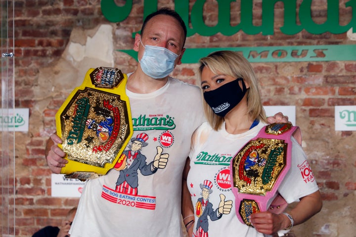 Competitive eaters Joey Chestnut, left, and Miki Sudo, right, pose for a photograph after winning their respective divisions