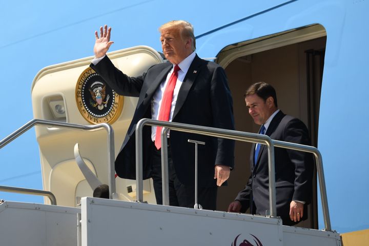 President Donald Trump and Arizona Governor Doug Ducey disembark from Air Force One in June. Ducey has joined in with Trump's dismissive stance on the virus.