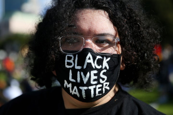 SYDNEY, AUSTRALIA - JULY 05: A woman looks on during a rally against Black Deaths in Custody in The Domain on July 05, 2020 in Sydney, Australia.The rally was organised to protest against Aboriginal and Torres Strait Islander deaths in custody and in solidarity with the global Black Lives Matter movement. (Photo by Don Arnold/Getty Images)