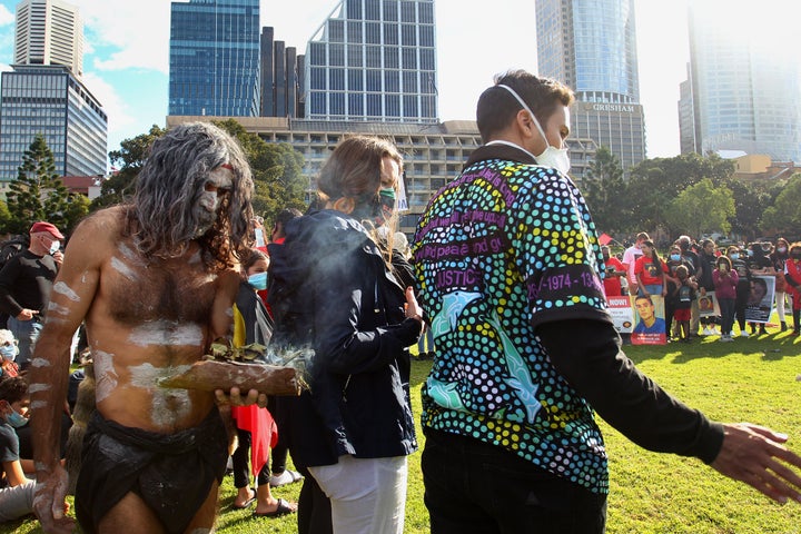 SYDNEY, AUSTRALIA - JULY 05: Aboriginal elders conduct a traditional smoking ceremony during a rally against Aboriginal and Torres Strait Islander deaths in custody in The Domain on July 05, 2020 in Sydney, Australia. Since the Royal Commission into Aboriginal deaths in custody ended in 1991 there have been over 400 deaths. Rallies have been organised across the country in solidarity with the global Black Lives Matter movement. (Photo by Lisa Maree Williams/Getty Images)