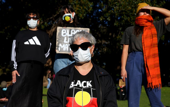 SYDNEY, AUSTRALIA - JULY 05: People look on during a rally against Black Deaths in Custody in The Domain on July 05, 2020 in Sydney, Australia.The rally was organised to protest against Aboriginal and Torres Strait Islander deaths in custody and in solidarity with the global Black Lives Matter movement. (Photo by Don Arnold/Getty Images)