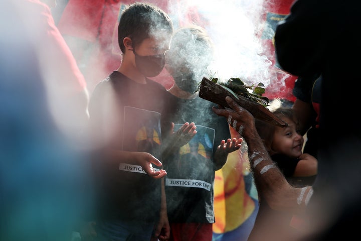 SYDNEY, AUSTRALIA - JULY 05: Young Aboriginal children take part in a traditional smoking ceremony during a rally against Aboriginal and Torres Strait Islander deaths in custody in The Domain on July 05, 2020 in Sydney, Australia. Since the Royal Commission into Aboriginal deaths in custody ended in 1991 there have been over 400 deaths. Rallies have been organised across the country in solidarity with the global Black Lives Matter movement. (Photo by Lisa Maree Williams/Getty Images)