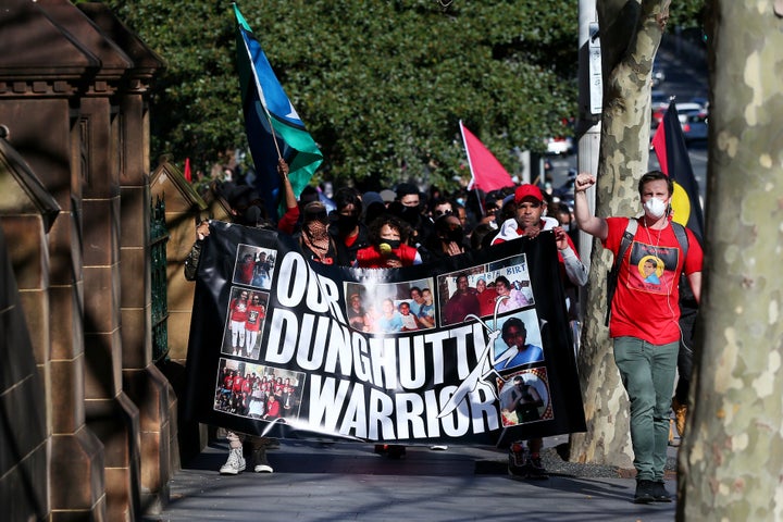 SYDNEY, AUSTRALIA - JULY 05: People march past St Mary's Cathedral during a rally against Black Deaths in Custody in The Domain on July 05, 2020 in Sydney, Australia.The rally was organised to protest against Aboriginal and Torres Strait Islander deaths in custody and in solidarity with the global Black Lives Matter movement. (Photo by Don Arnold/Getty Images)