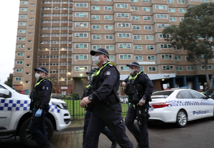 Police officers walk as they enforce a lockdown in response to an outbreak of coronavirus in Melbourne.