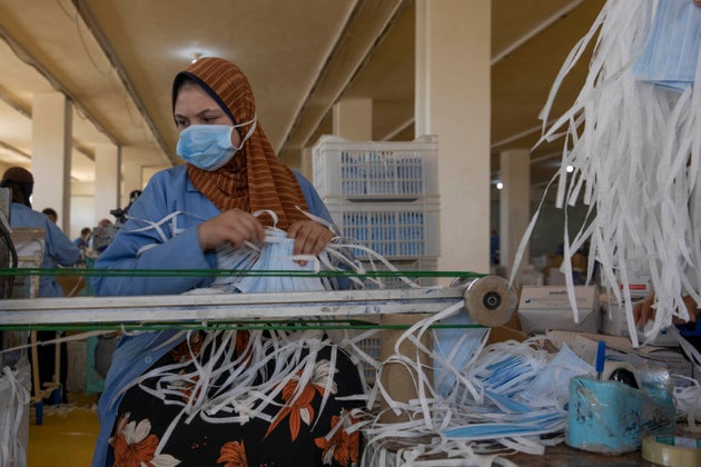 A woman working at Medic Egypt for Medical Clothes company makes protective face masks to be used to...