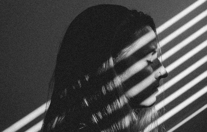 Streams of lights on a young woman's face