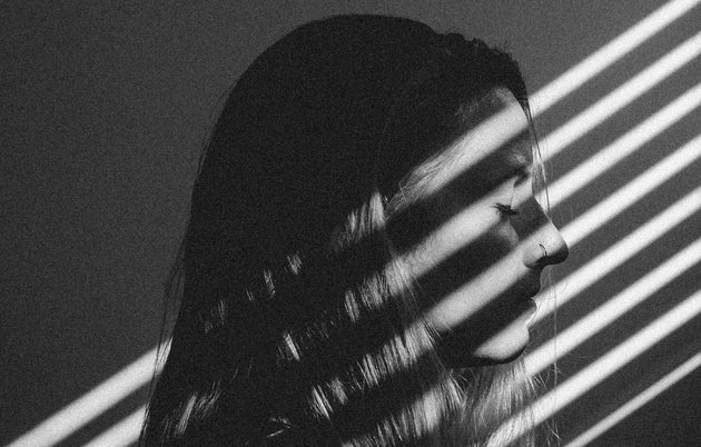 Streams of lights on a young woman's face