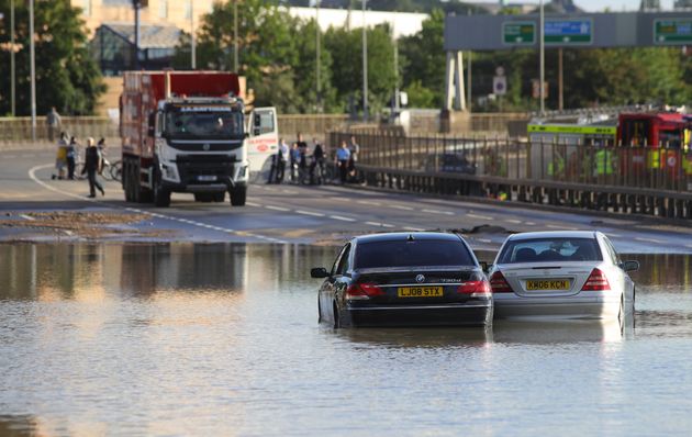 Abandoned cars in flood water on the North Circular road near Brent Cross, north London, after a water main burst.