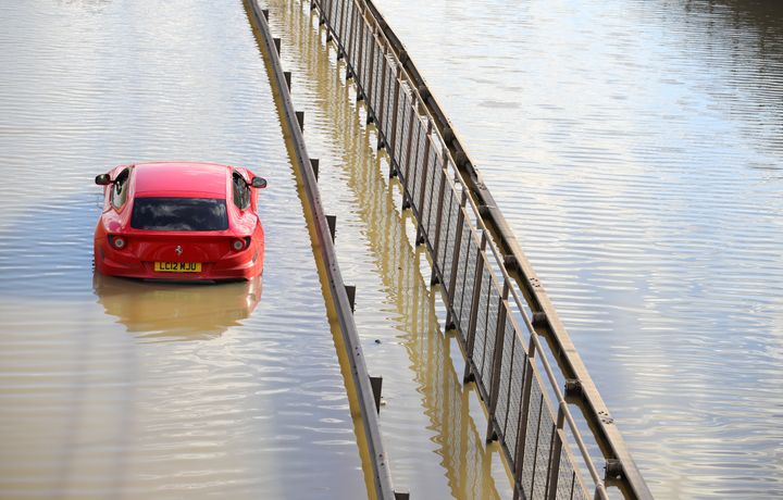 An abandoned Ferrari in flood water on the North Circular road near Brent Cross, north London, after a water main burst.