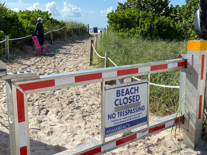 A sign announces beach closure to prevent the spread of the coronavirus ahead of the Fourth of July weekend in Miami Beach, Florida.