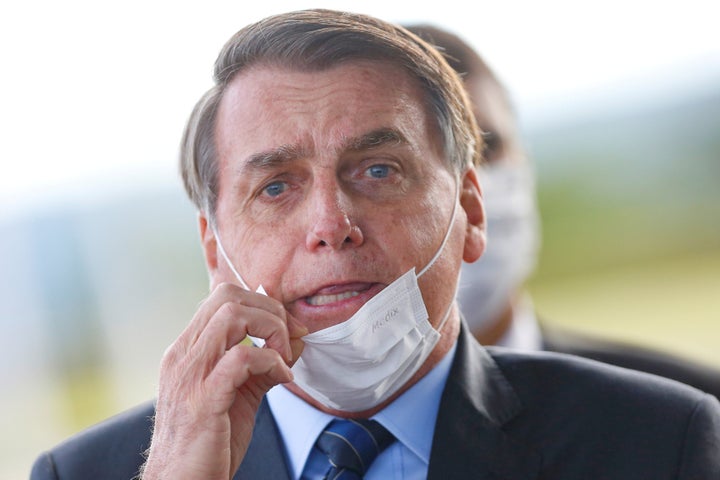 Brazil's President Jair Bolsonaro adjusts his mask as he leaves Alvorada Palace, amid the coronavirus disease (COVID-19) outbreak in Brasilia, Brazil May 13.