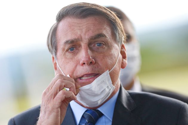 Brazil's President Jair Bolsonaro adjusts his mask as he leaves Alvorada Palace, amid the coronavirus disease (COVID-19) outbreak in Brasilia, Brazil May 13.