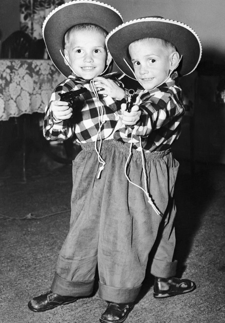 Siamese twins Ronnie and Donnie Galyon pose in their cowboy suits on their third birthday.