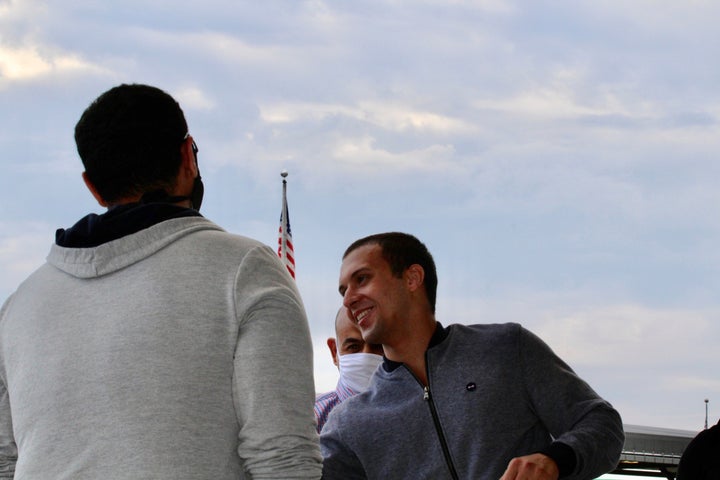 Mohamed Amashah is greeted by family members upon arrival at Dulles International Airport on Monday. The American medical student detained without trial in an Egyptian prison for nearly 500 days has been freed.